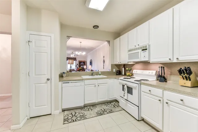 a kitchen with appliances cabinets and a counter top space