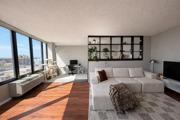 a bedroom with a bed chair and a desk