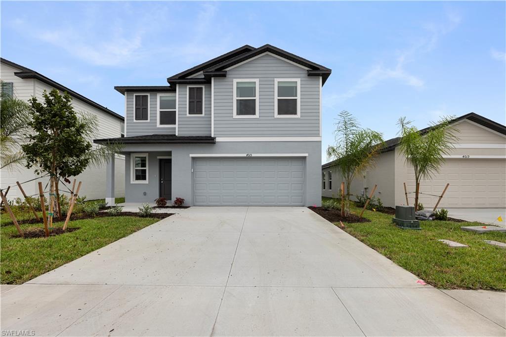 a front view of a house with a yard and garage