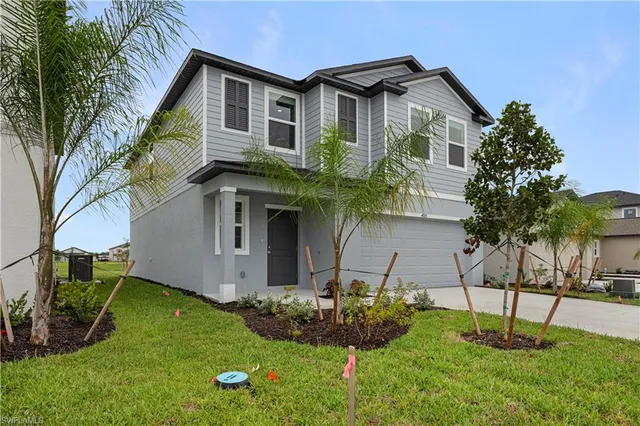 a front view of house with a garden