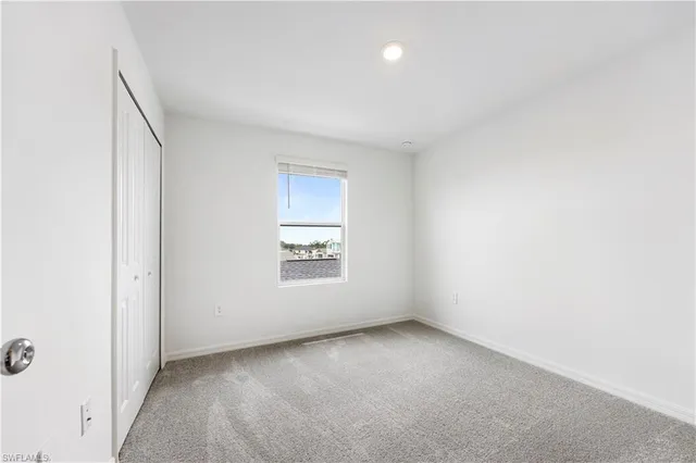 a view of a closet area with ceiling fan