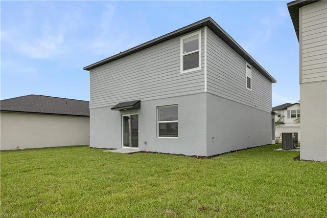 a view of a backyard with plants and a garage