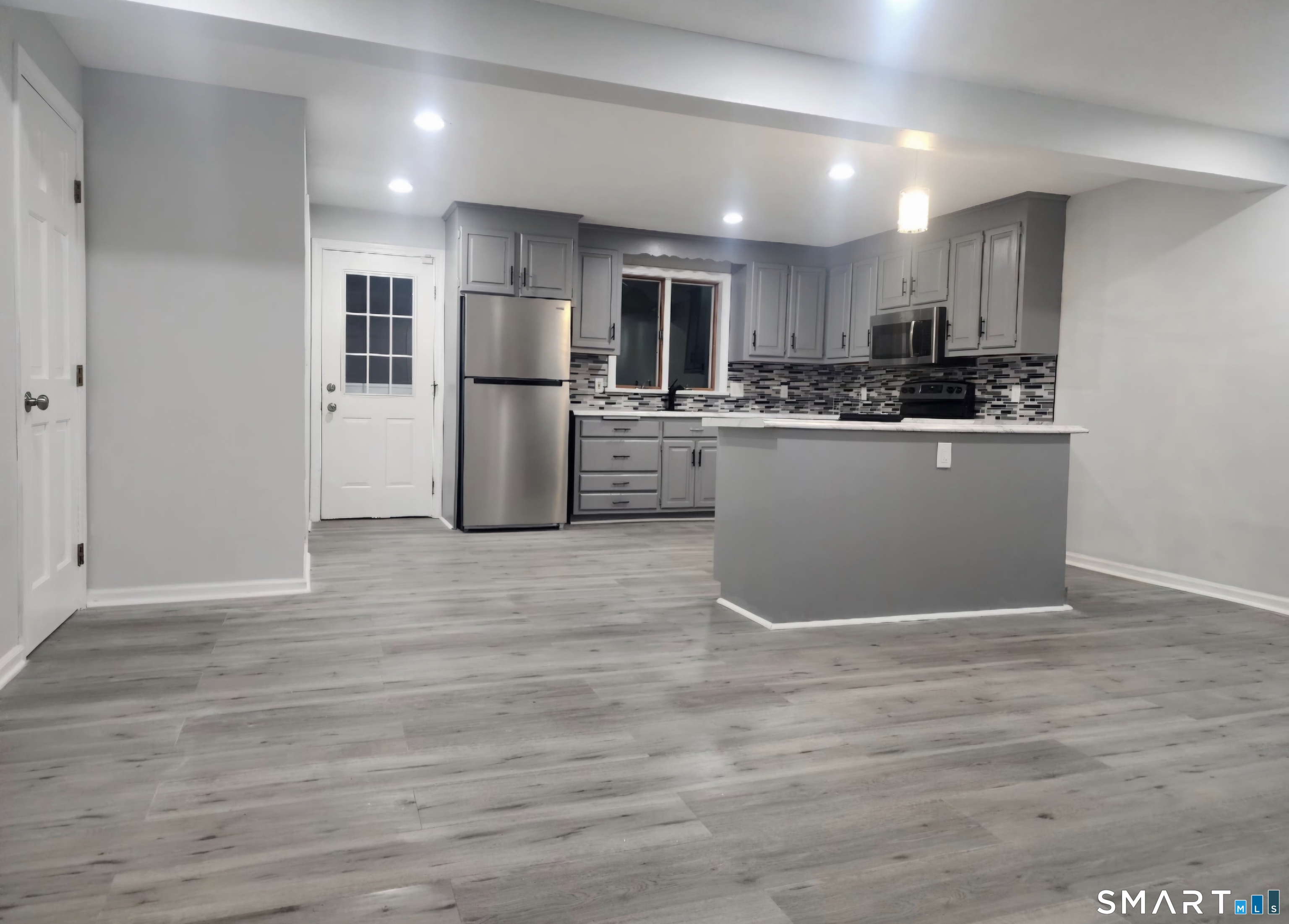 a kitchen with stainless steel appliances granite countertop a refrigerator and a stove top oven