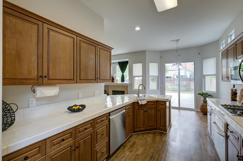 3235 Rall Avenue Clovis, CA 93619 - Photo 16 of 33 a kitchen with a sink stove and cabinets