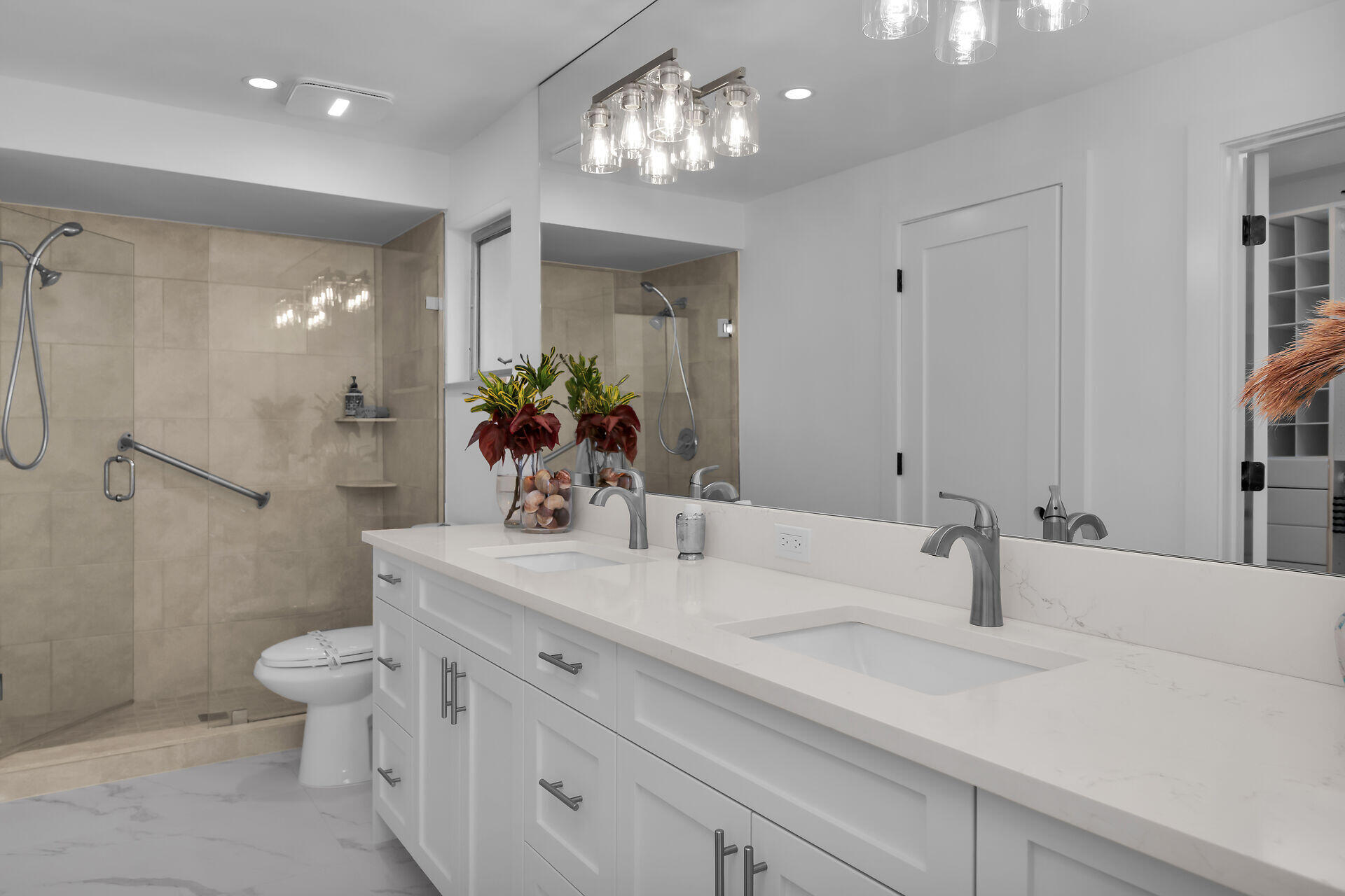 178 Torrey Pines Naples, FL 34113 - Photo 17 of 48 a bathroom with a double vanity sink mirror and toilet