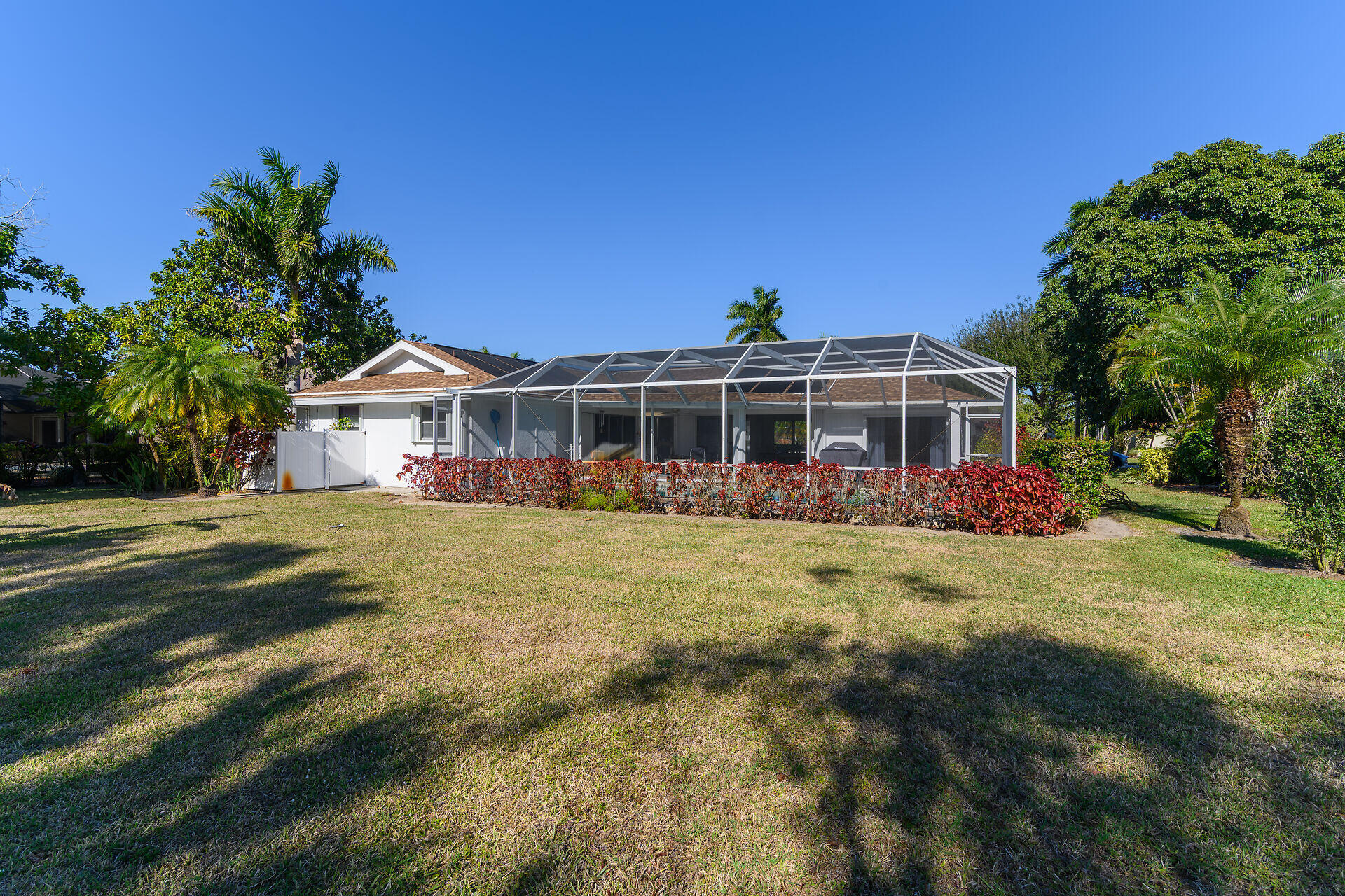 178 Torrey Pines Naples, FL 34113 - Photo 32 of 48 a view of a house with a yard patio and wooden fence