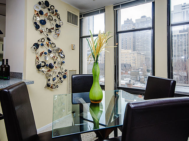 1 East Scott Street, Unit 604 Chicago, IL 60610 - Photo 5 of 11 a living room with furniture and a floor to ceiling window