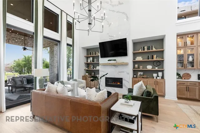 a living room with furniture a fireplace and a flat screen tv
