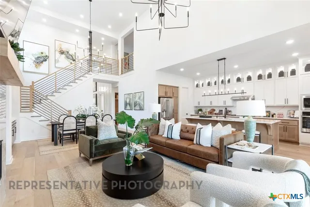a living room with furniture and a chandelier