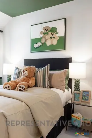 a bedroom with a bed and a painting on the wall