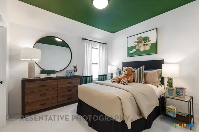 a bedroom with a bed and a mirror