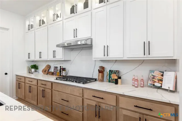 a kitchen with white cabinets and white appliances