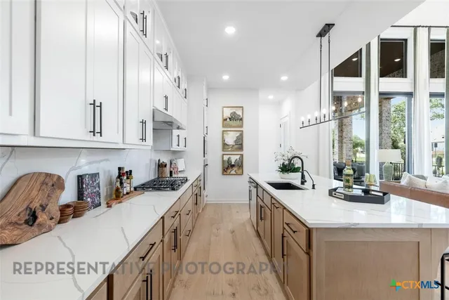 a kitchen with lots of counter space and windows