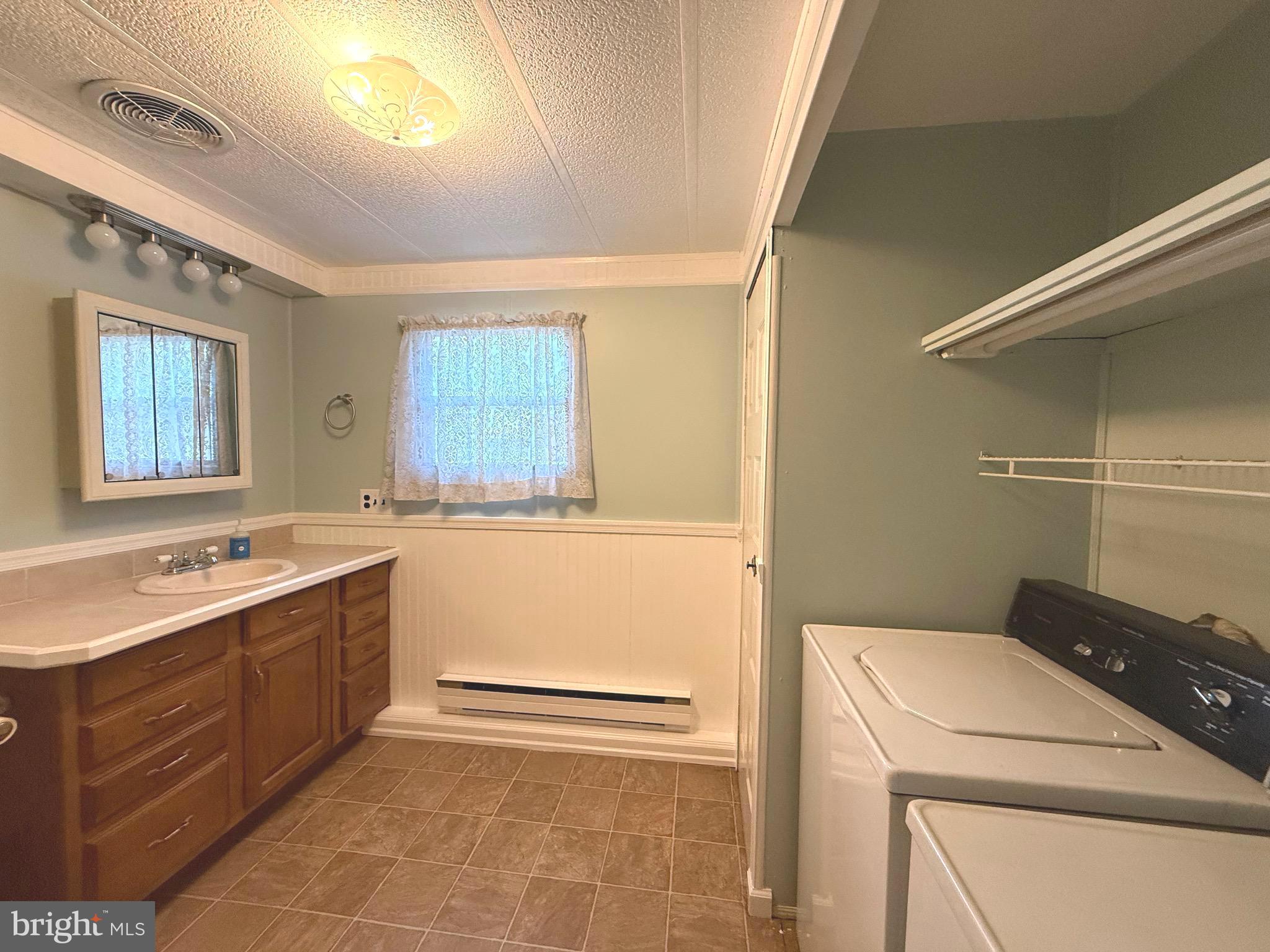 87 Holly Court Tabernacle, NJ 08088 - Photo 11 of 24 a utility room with cabinets washer and dryer