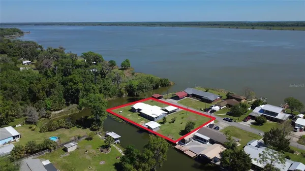 an aerial view of a pool yard lake and outdoor seating