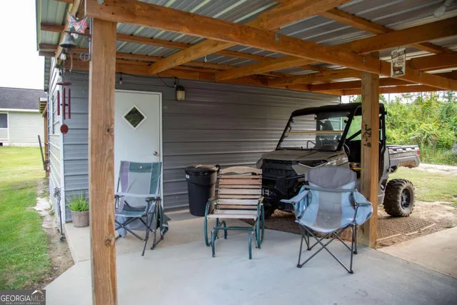 a kitchen with a refrigerator a stove a sink a dining table and chairs