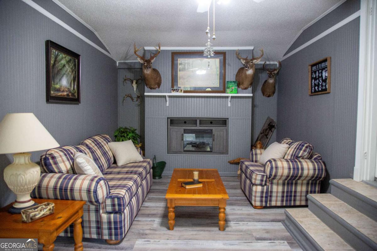 1758 Easons Bluff Road Baxley, GA 31513 - Photo 28 of 50 a living room with furniture and a fireplace