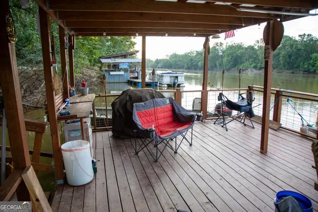 a view of deck with table and chairs potted plants with wooden floor