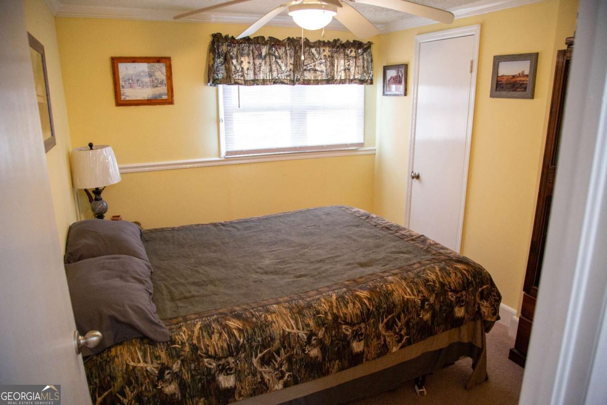 1758 Easons Bluff Road Baxley, GA 31513 - Photo 31 of 50 a bedroom with a bed and window
