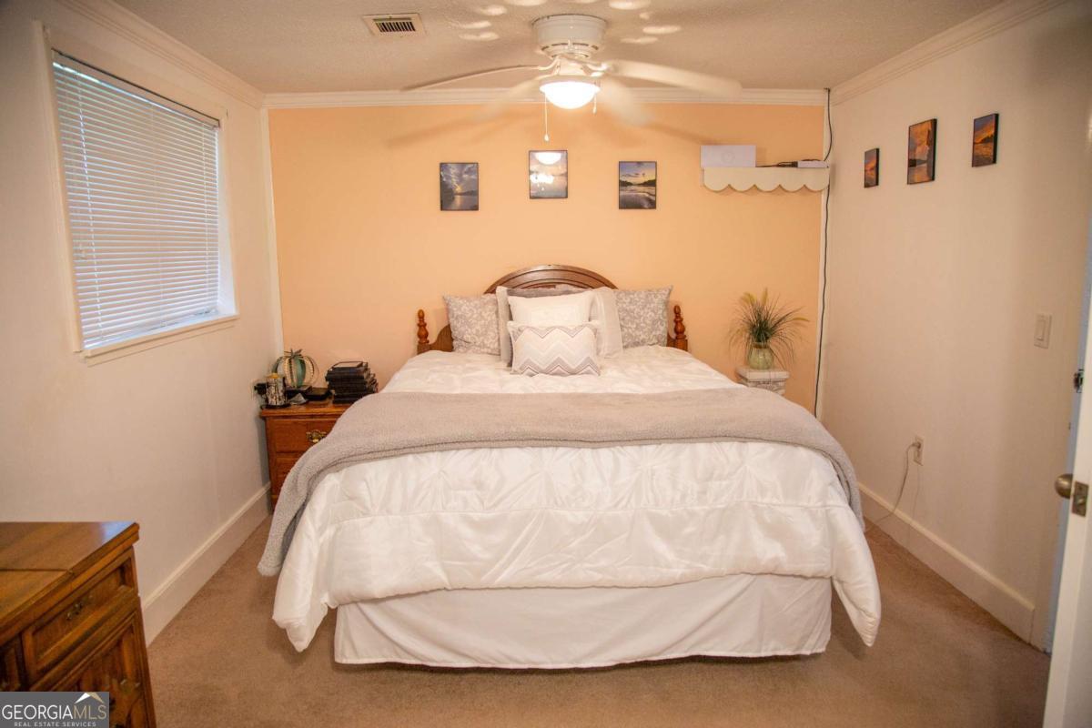 1758 Easons Bluff Road Baxley, GA 31513 - Photo 34 of 50 a bedroom with a bed and a night stand