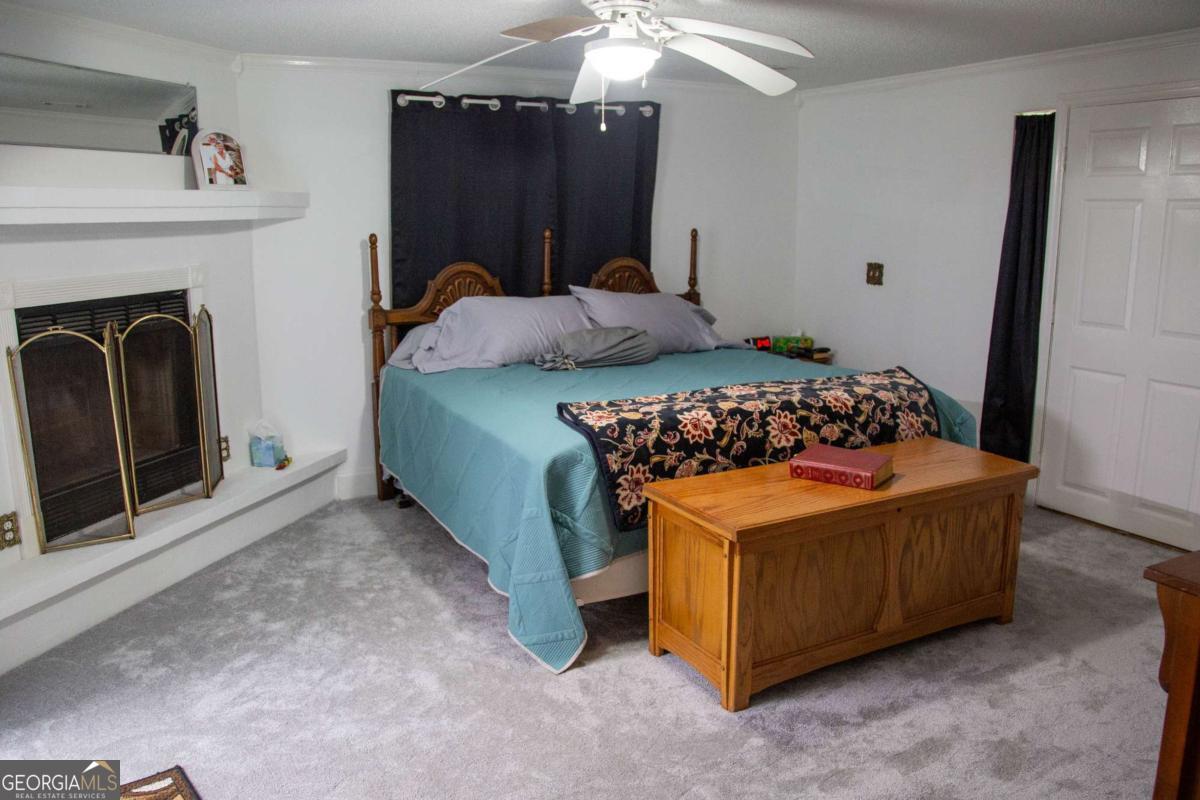 1758 Easons Bluff Road Baxley, GA 31513 - Photo 36 of 50 a bedroom with a bed and a fireplace