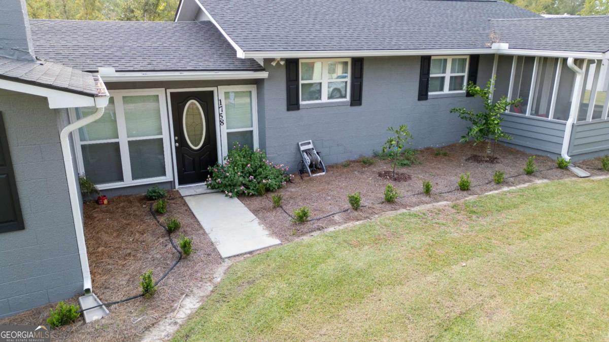 1758 Easons Bluff Road Baxley, GA 31513 - Photo 9 of 50 a front view of a house with garden