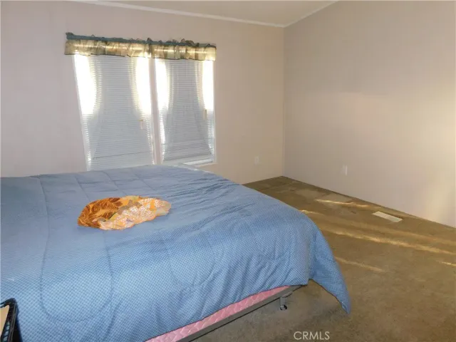 a view of a room with wooden floor and cabinet