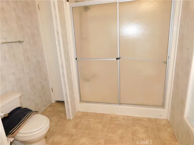 a bathroom with a glass shower door