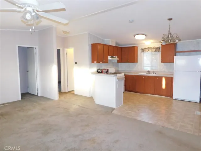 a view of a kitchen with a sink and chandelier