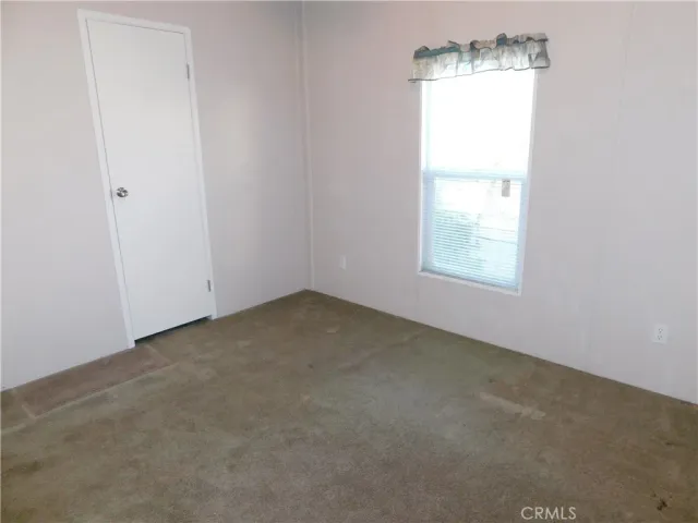 an empty room with an entryway door