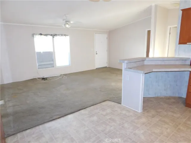 an empty room with windows and entrance