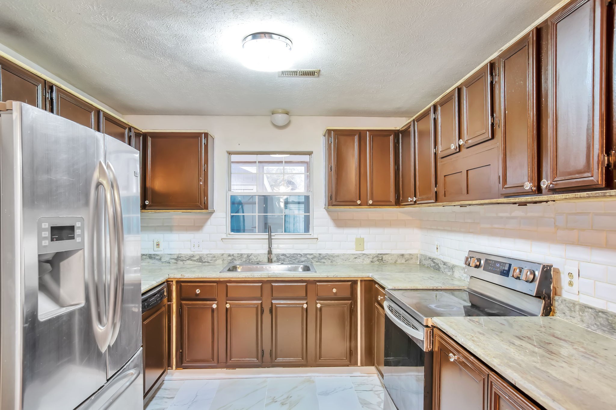 3296 Anderson Road Antioch, TN 37013 - Photo 6 of 25 a kitchen with stainless steel appliances granite countertop a sink stove and refrigerator