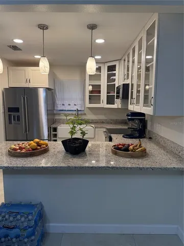 a kitchen with a refrigerator and a stove