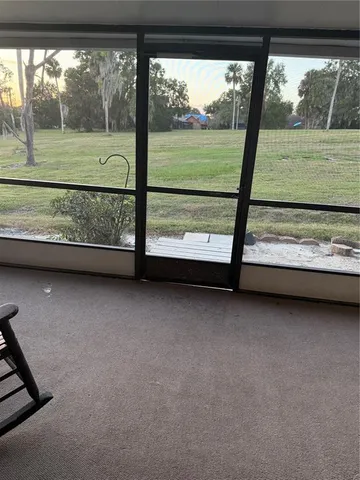 a view of a room with a yard from a balcony
