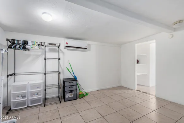 a view of a utility room with cabinets
