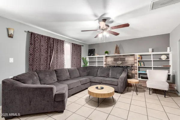 a living room with furniture and a chandelier