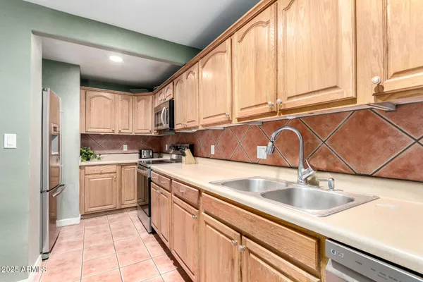 a kitchen with stainless steel appliances granite countertop a sink and cabinets