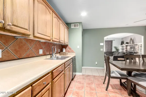 a kitchen with a stove a sink and a cabinets