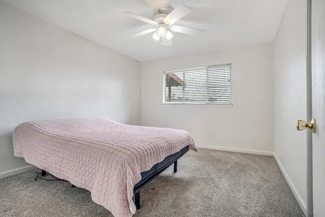 a bedroom with a bed and a window