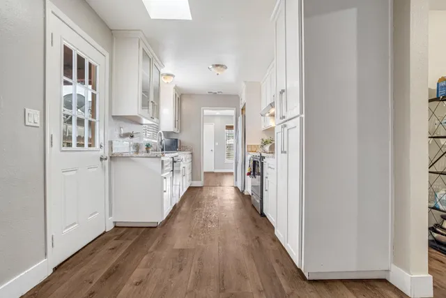 a view of a kitchen with a refrigerator and a stove