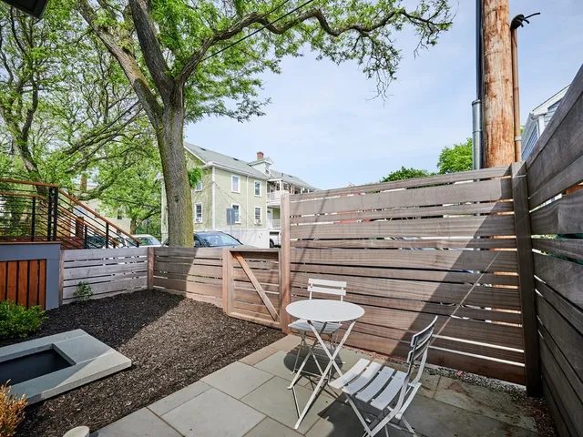 a view of patio with table and chairs and potted plants