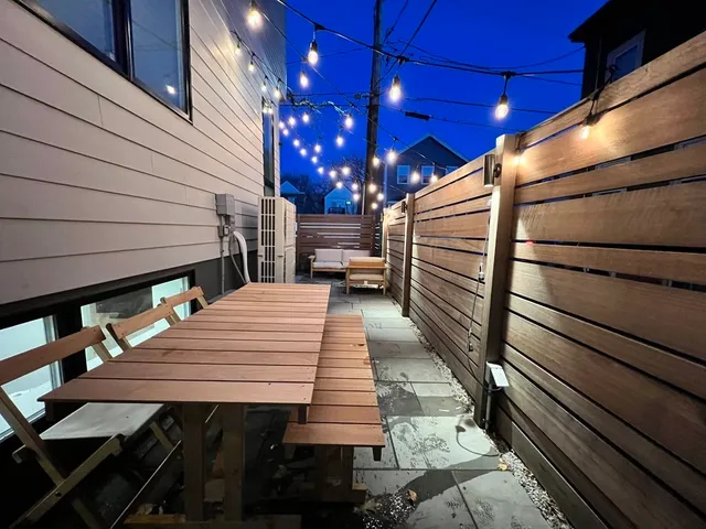 a view of a house with a yard and large tree
