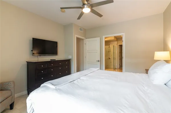 a bedroom with a bed and a flat screen tv