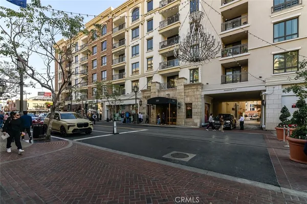 a couple of cars parked in front of brick building