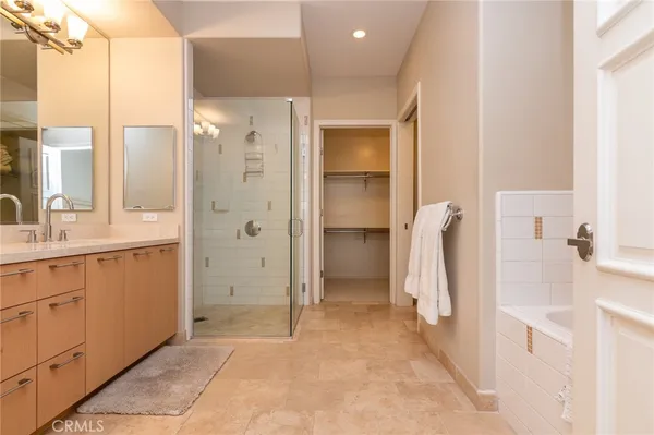 a bathroom with a double sink shower and a mirror