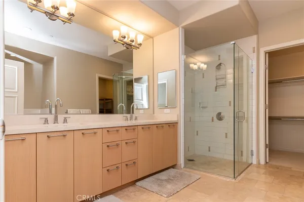 a spacious bathroom with a shower sink and mirror