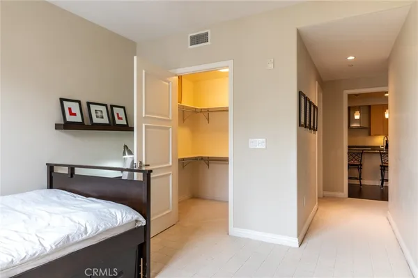 a bedroom with a bed and a view of kitchen