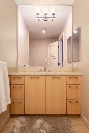 a bathroom with a sink vanity and mirror