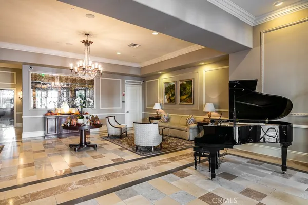 a living room with furniture and a chandelier