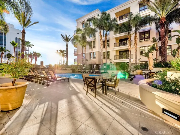a view of a patio with couches table and chairs and potted plants